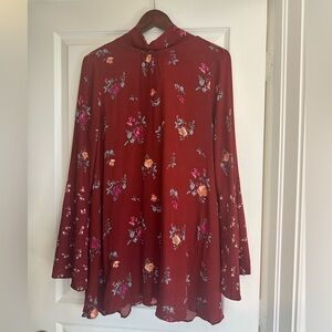 Free people dress burgundy with flower design. Bell hands
